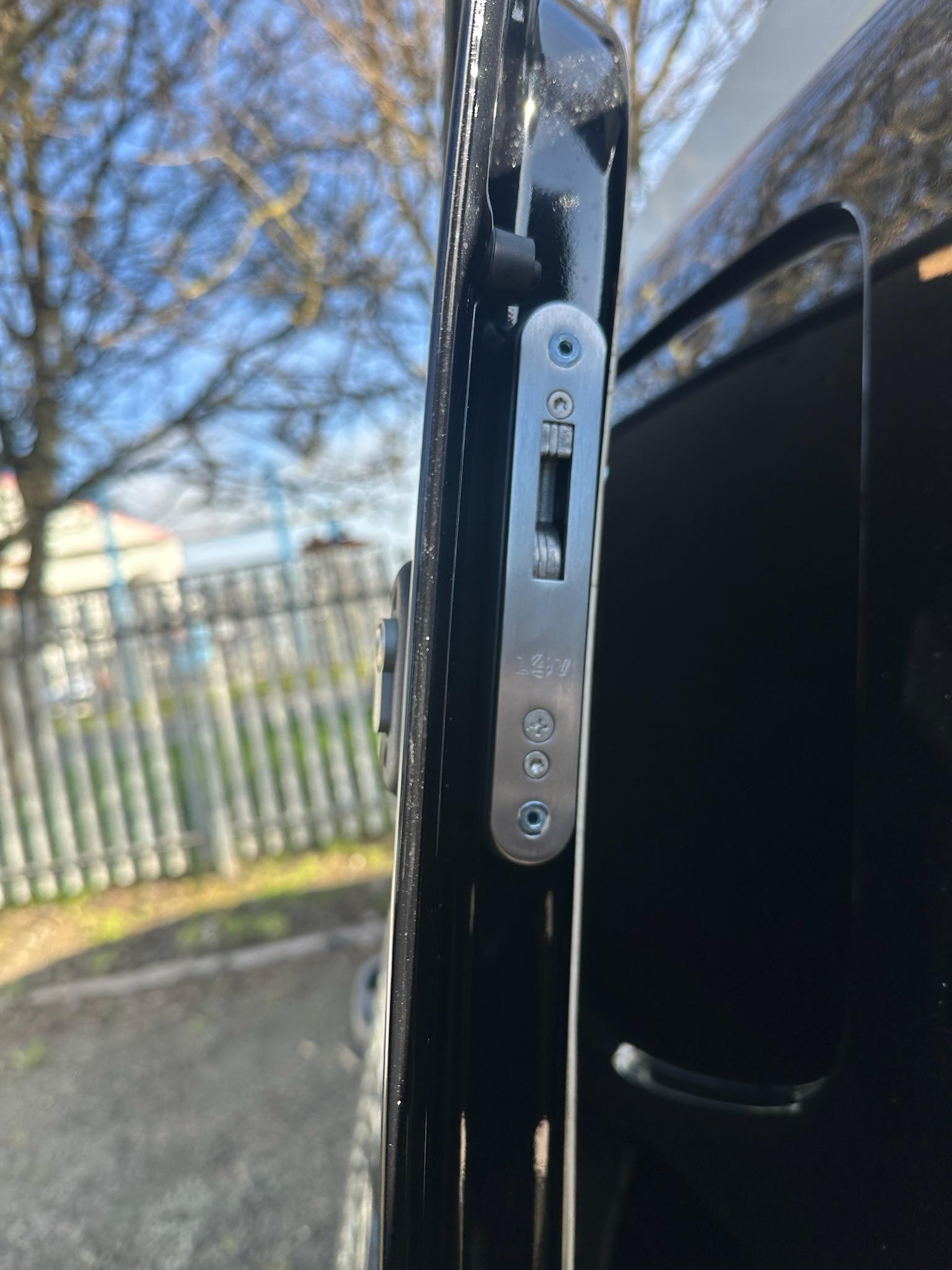 Deadlock mechanism fitted inside black van door frame