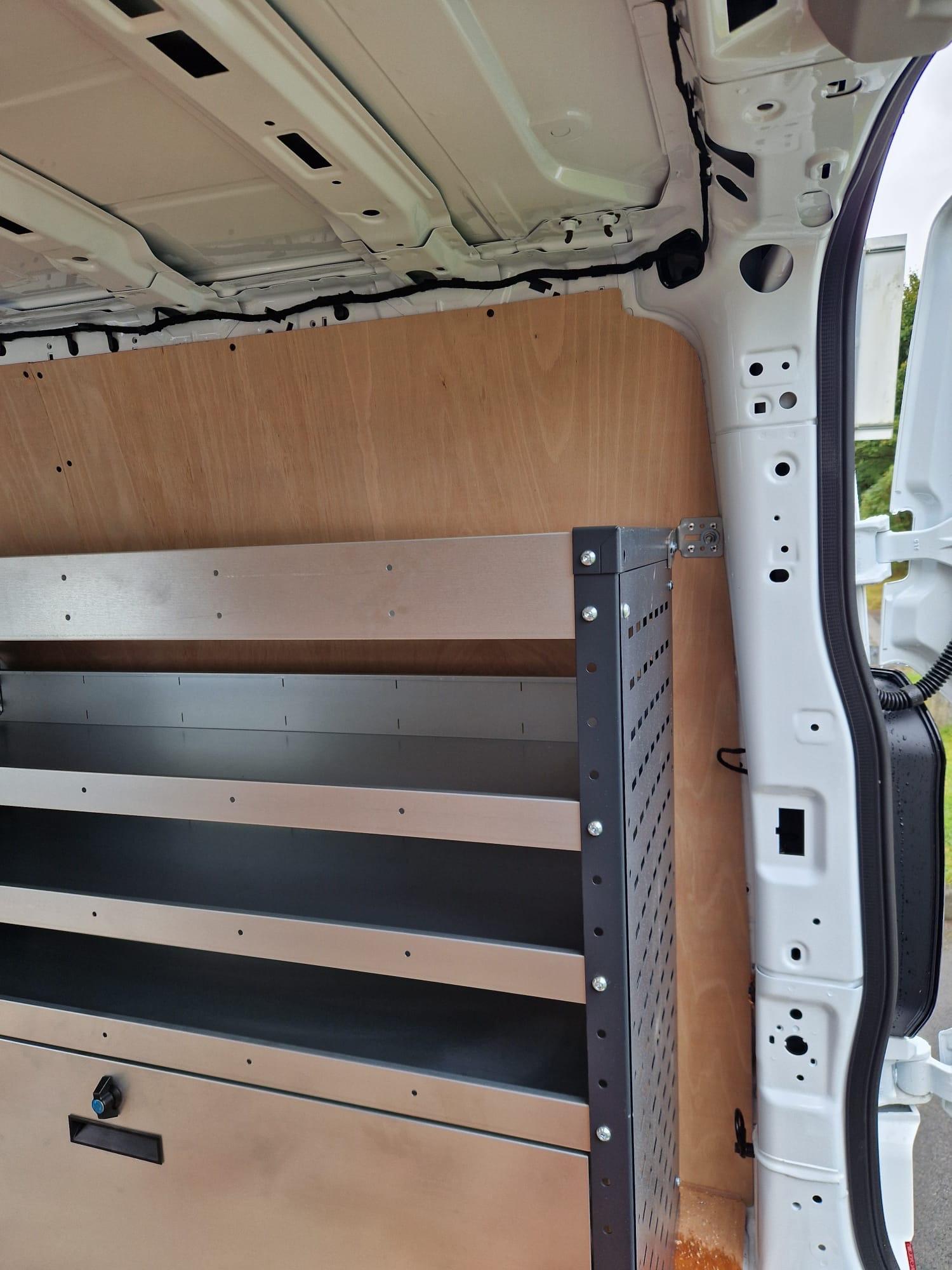 Metal racking system with drawers and shelves in large van