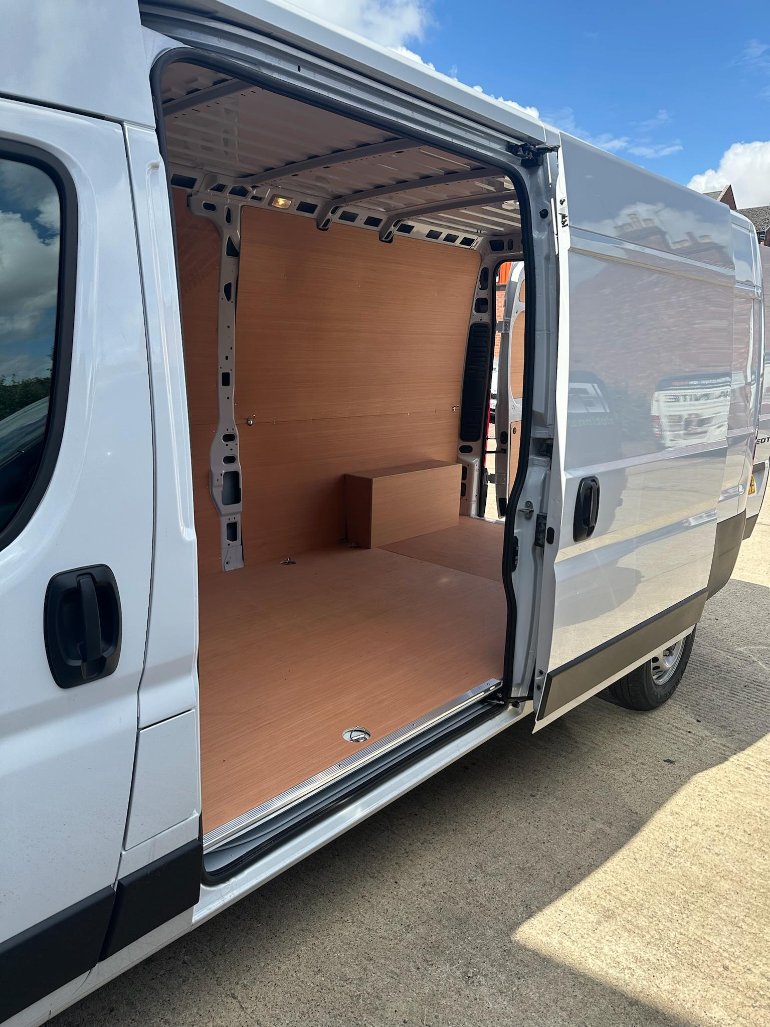 Ply lining visible through side sliding door of large van