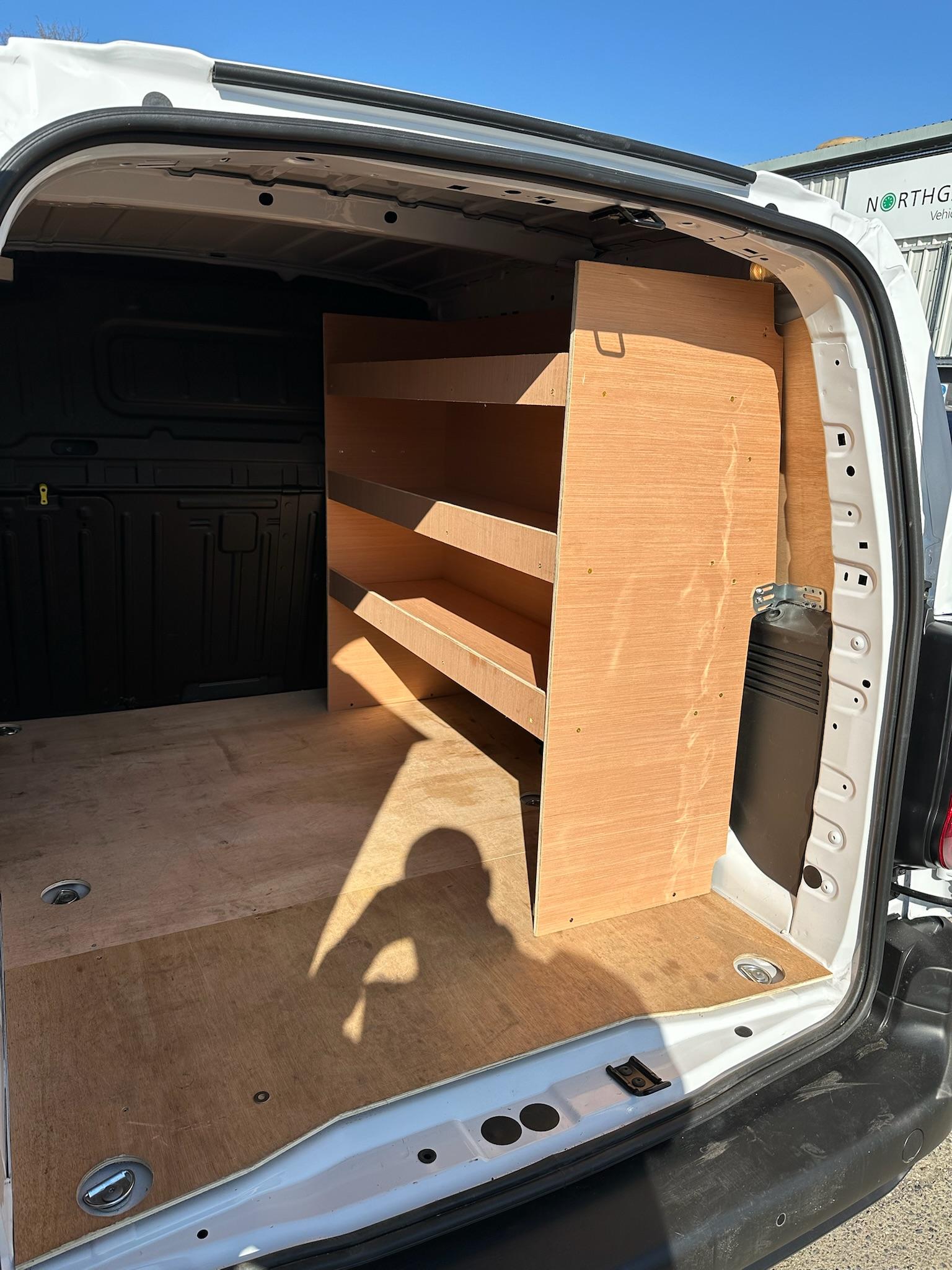 Custom wood racking shelves in small van cargo area